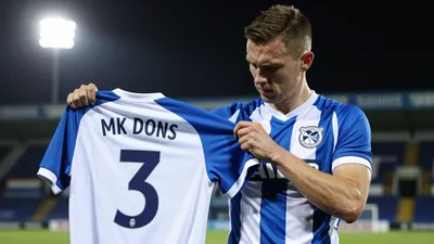 Cheltenham Town have signed versatile defender Joe Tomlinson from MK Dons, with the 26-year-old left-back joining on a...